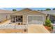 Inviting home exterior with a well-maintained yard and a screened-in porch at 2805 Burgos Dr, The Villages, FL 32162
