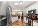 Well-equipped kitchen with stainless steel appliances and granite countertops overlooking the living area at 2805 Burgos Dr, The Villages, FL 32162