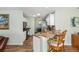 Bright kitchen featuring stainless steel appliances, granite countertops, and convenient bar seating at 2805 Burgos Dr, The Villages, FL 32162