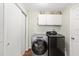 Modern laundry room equipped with sleek appliances and storage at 2805 Burgos Dr, The Villages, FL 32162