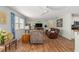 Cozy living room with comfortable seating and bright window, open to the dining area at 2805 Burgos Dr, The Villages, FL 32162