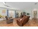 Inviting living room featuring a ceiling fan, comfortable seating, and convenient access to bathroom at 2805 Burgos Dr, The Villages, FL 32162