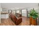Spacious living room with an open layout to the dining area and kitchen, featuring modern flooring at 2805 Burgos Dr, The Villages, FL 32162