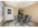 A glass topped table with seating is on the screened-in lanai with a ceiling fan at 2805 Burgos Dr, The Villages, FL 32162