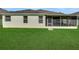 Lush backyard featuring a covered patio for outdoor dining and leisure at 30532 Gidran Ter, Mount Dora, FL 32757