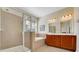 Bathroom featuring a glass-enclosed shower, soaking tub, and double vanity at 30532 Gidran Ter, Mount Dora, FL 32757