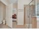 Bathroom featuring a glass-enclosed shower, and a view to the main bedroom at 30532 Gidran Ter, Mount Dora, FL 32757