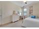 This bedroom offers a comfortable bed, a dresser, and natural light from the window at 30532 Gidran Ter, Mount Dora, FL 32757