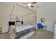Bedroom with a four-poster bed, vanity, and view to hallway at 30532 Gidran Ter, Mount Dora, FL 32757