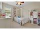 This bedroom showcases a four-poster bed, a dresser, and a shelving unit for storage at 30532 Gidran Ter, Mount Dora, FL 32757