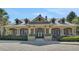 The exterior of the clubhouse is adorned with stone pillars, arched windows, and well-maintained landscaping at 30532 Gidran Ter, Mount Dora, FL 32757