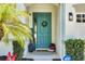 Close-up of front entrance with a blue door, wreath, and charming decor at 30532 Gidran Ter, Mount Dora, FL 32757