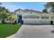 Beautiful single-story home with a well-maintained lawn and a spacious three-car garage at 30532 Gidran Ter, Mount Dora, FL 32757
