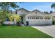 Charming single-story home featuring a well-manicured lawn and a three-car garage at 30532 Gidran Ter, Mount Dora, FL 32757