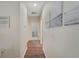 Hallway with hardwood floors and white walls leading to other rooms in the home at 30532 Gidran Ter, Mount Dora, FL 32757