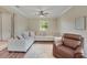 Comfortable living room area with a plush sectional sofa and a cozy armchair at 30532 Gidran Ter, Mount Dora, FL 32757