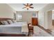 Main bedroom with hardwood floors, ceiling fan, and ensuite bathroom at 30532 Gidran Ter, Mount Dora, FL 32757