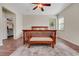 Main bedroom with hardwood floors, ceiling fan, and a view to other rooms in the home at 30532 Gidran Ter, Mount Dora, FL 32757
