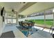Covered patio complete with ceiling fan, outdoor dining set, and view of the fenced backyard at 30532 Gidran Ter, Mount Dora, FL 32757