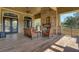 Covered patio with a stone fireplace, outdoor seating, and access to the lush backyard at 30532 Gidran Ter, Mount Dora, FL 32757