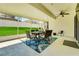 Outdoor covered patio with dining table, chairs, ceiling fan, and view of backyard at 30532 Gidran Ter, Mount Dora, FL 32757