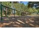 Park swings surrounded by beautiful trees and landscaping, community common area at 30532 Gidran Ter, Mount Dora, FL 32757