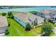 Back of home with lush lawn leads to lake at 313 Blue Cypress Dr, Groveland, FL 34736