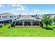 Expansive backyard with a large screened-in lanai, perfect for outdoor entertaining and enjoying the beautiful scenery at 313 Blue Cypress Dr, Groveland, FL 34736