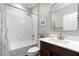 Clean bathroom with white subway tile, dark wood vanity, and tiled shower at 313 Blue Cypress Dr, Groveland, FL 34736