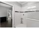 White tiled walk-in shower with mosaic stripe and glass door at 313 Blue Cypress Dr, Groveland, FL 34736