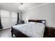 Cozy bedroom with a dark wood bed frame, a leather chair, and side tables; perfect for relaxation and comfort at 313 Blue Cypress Dr, Groveland, FL 34736