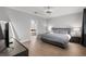 Bright bedroom features a contemporary bed frame, wood floors, and an ensuite bathroom at 313 Blue Cypress Dr, Groveland, FL 34736
