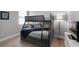 ' room with gray bunk beds, a soft blue blanket, light-colored flooring, and a framed cartoon print at 313 Blue Cypress Dr, Groveland, FL 34736