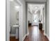 Bright entryway features wood floors, a pendant light, and a view of a half bathroom at 313 Blue Cypress Dr, Groveland, FL 34736
