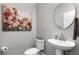 Small half bathroom with pedestal sink and decorative wall art at 313 Blue Cypress Dr, Groveland, FL 34736
