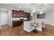 Modern kitchen featuring granite countertops, stainless appliances, and seating at the island at 313 Blue Cypress Dr, Groveland, FL 34736