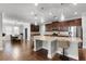 Open concept kitchen features stainless appliances, granite countertops and pendant lighting at 313 Blue Cypress Dr, Groveland, FL 34736