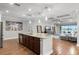 This modern kitchen opens up to the living room, featuring granite countertops and recessed lighting at 313 Blue Cypress Dr, Groveland, FL 34736