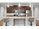Kitchen island features barstool seating, ample counter space, and stainless appliances at 313 Blue Cypress Dr, Groveland, FL 34736