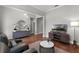 Spacious living room features a modern light fixture, wood floors and updated furniture at 313 Blue Cypress Dr, Groveland, FL 34736