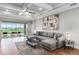 Spacious living room with tray ceiling and sliding doors to the outdoor patio at 313 Blue Cypress Dr, Groveland, FL 34736