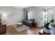 Cozy living room featuring wood floors, two chairs and bright lighting at 313 Blue Cypress Dr, Groveland, FL 34736