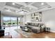 Elegant living room with tray ceiling, patio access, and comfortable seating at 313 Blue Cypress Dr, Groveland, FL 34736