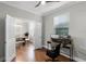 Versatile office space with a modern desk setup, adjacent to a dining area with natural light at 313 Blue Cypress Dr, Groveland, FL 34736