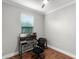 Home office featuring a computer desk setup, a comfortable chair, and hardwood floors at 313 Blue Cypress Dr, Groveland, FL 34736