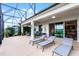 Relaxing outdoor patio featuring lounge chairs and views of the lake at 313 Blue Cypress Dr, Groveland, FL 34736