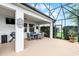 Covered and screened patio with outdoor dining for enjoying outdoor living at 313 Blue Cypress Dr, Groveland, FL 34736