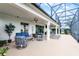 Expansive screened patio with comfortable seating, perfect for entertaining guests outdoors at 313 Blue Cypress Dr, Groveland, FL 34736