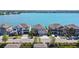 Aerial view of waterfront homes showcasing a beautiful lake and neighborhood at 395 Blue Cypress Dr, Groveland, FL 34736