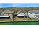 Beautiful waterfront property featuring a well-maintained lawn, screened-in patio, and solar panels for energy efficiency at 395 Blue Cypress Dr, Groveland, FL 34736